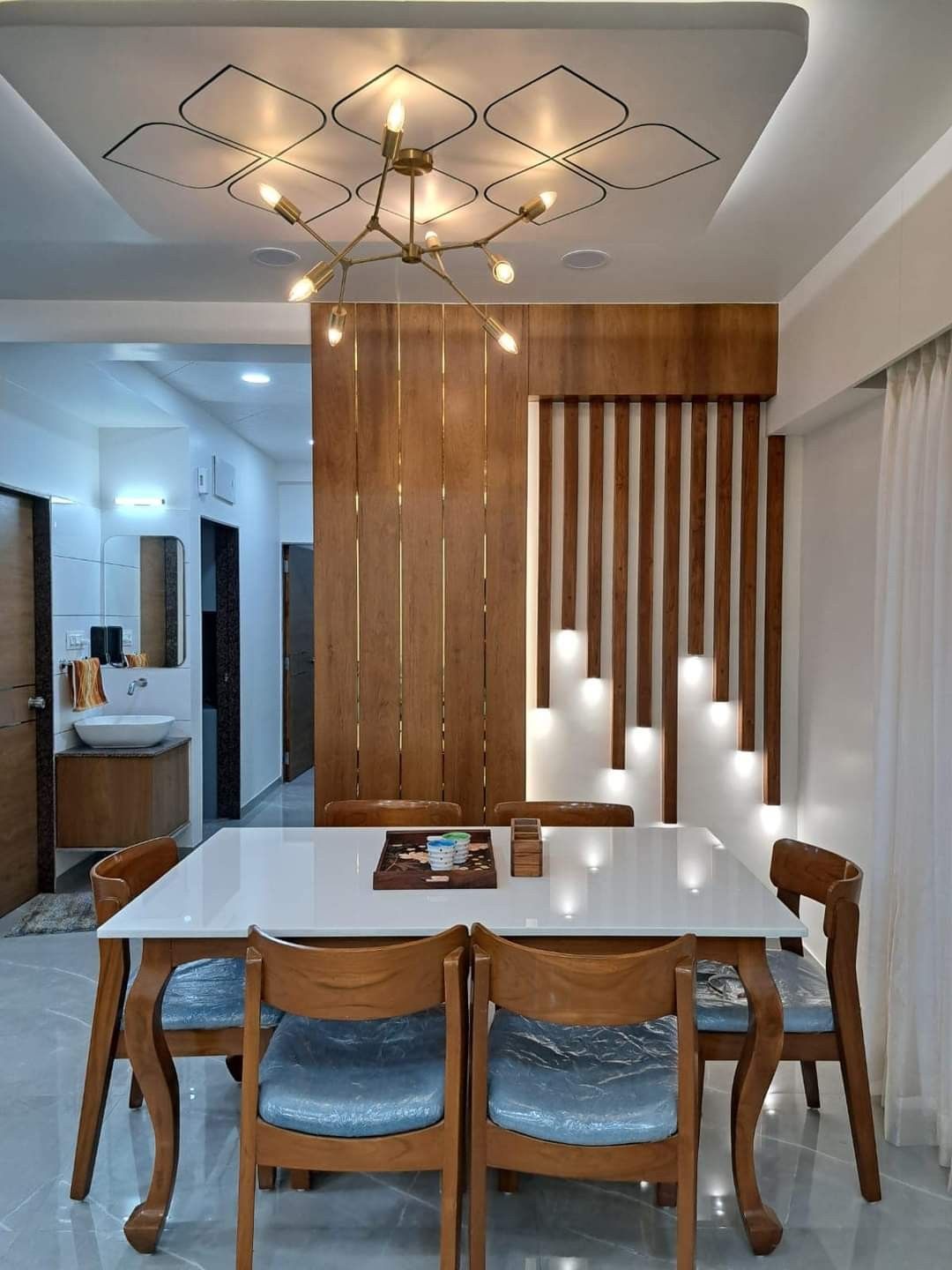 Contemporary Dining Room with Wood Slat Accent Wall and Modern Chandelier