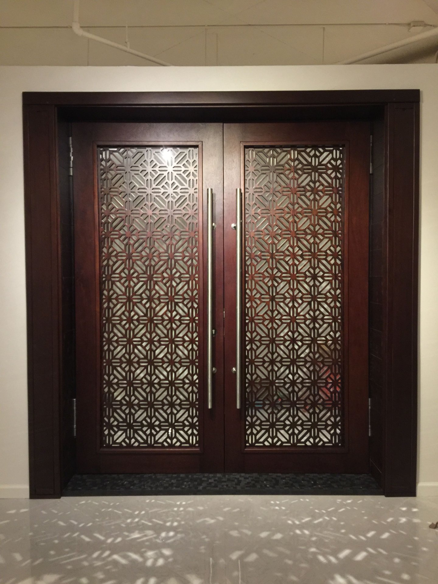 Elegant Double Entry Doors with Geometric Wood Lattice