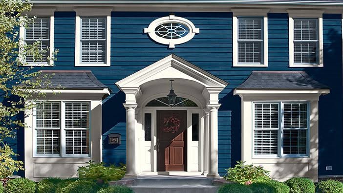 Classic Colonial House with Blue Siding and Elegant Entryway