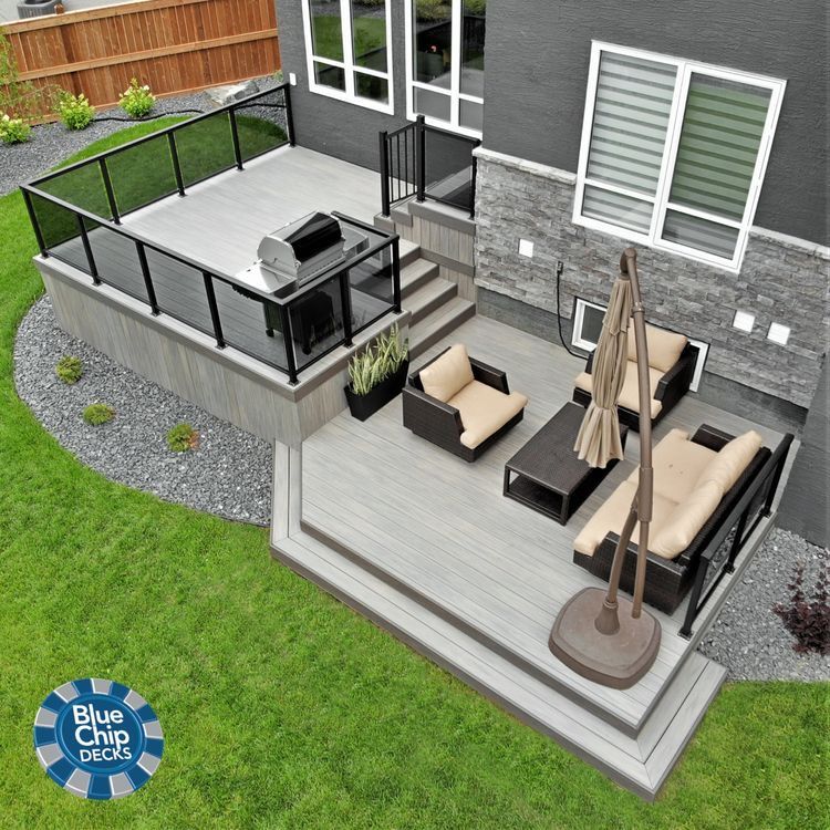 Modern multi-level backyard deck with seating and grill area