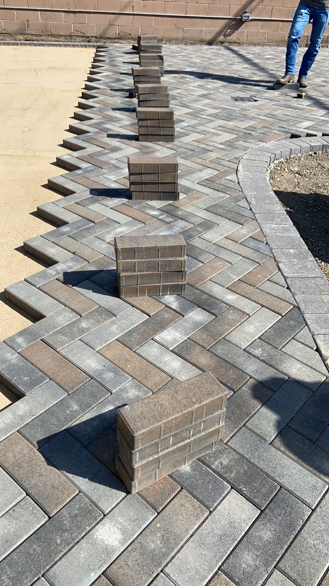 Herringbone Pattern Paver Patio Installation with Stacked Brick Borders