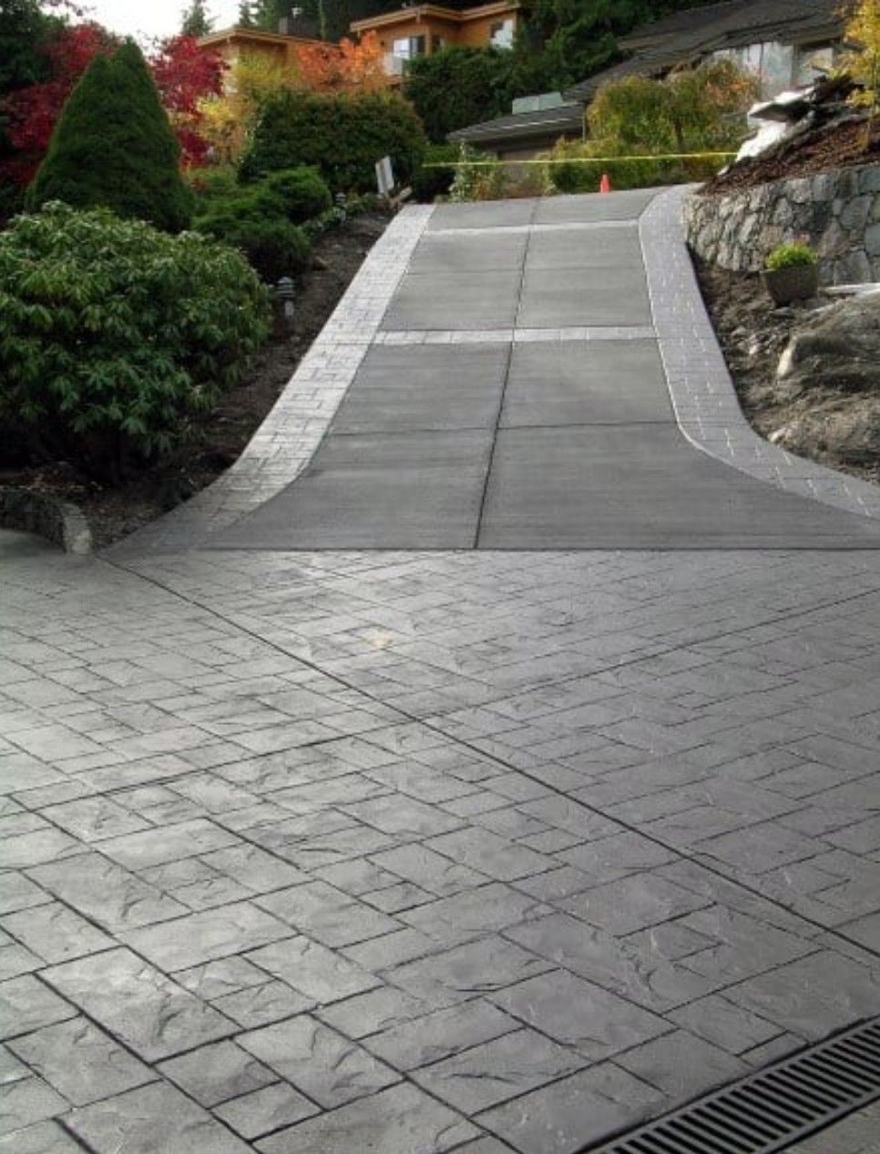 Modern Stamped Concrete Driveway with Decorative Borders and Slope